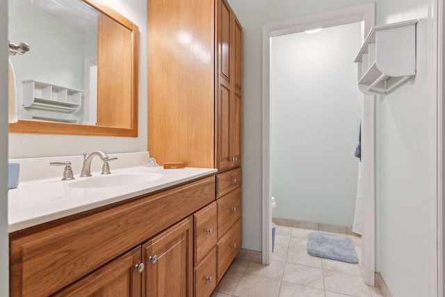 bathroom with tile patterned flooring, vanity, and toilet