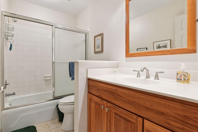 full bathroom featuring vanity, tile patterned floors, shower / bath combination with glass door, and toilet