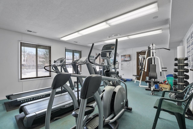 exercise room with a textured ceiling