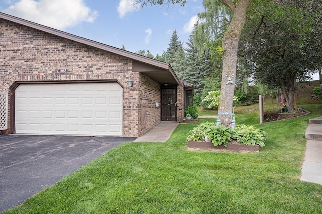 view of side of home with a garage and a yard