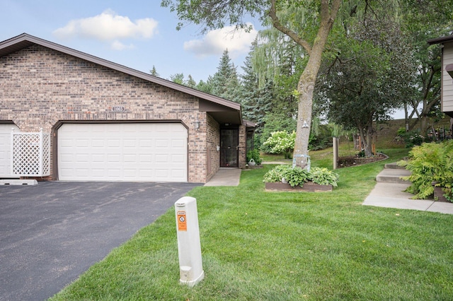 view of front of house featuring a garage and a front lawn