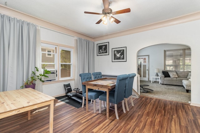 dining area with ceiling fan, dark colored carpet, cooling unit, and crown molding