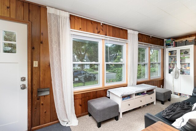 interior space featuring multiple windows and wooden walls