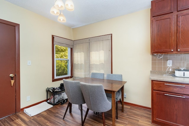 dining room with wood-type flooring and a notable chandelier