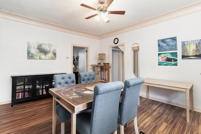 dining area with dark hardwood / wood-style flooring, crown molding, and ceiling fan