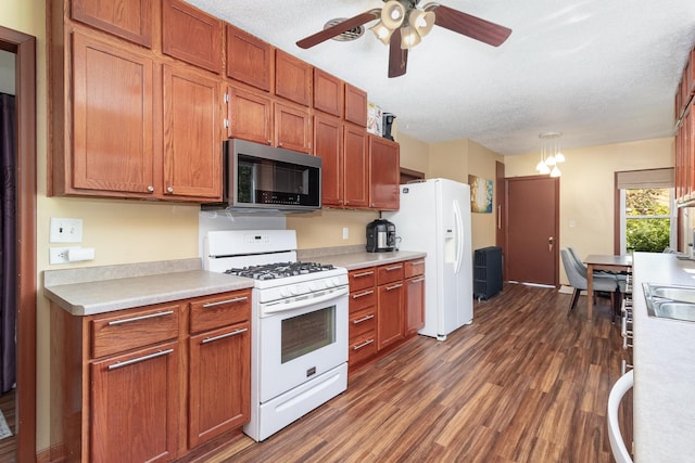 kitchen featuring ceiling fan, dark wood-type flooring, a textured ceiling, and white appliances