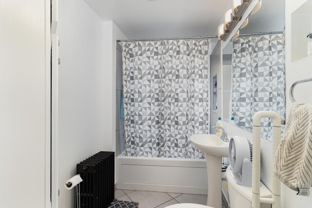 bathroom with radiator heating unit, toilet, shower / bath combo with shower curtain, and tile patterned floors