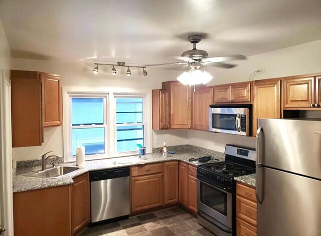 kitchen featuring appliances with stainless steel finishes, sink, tile patterned floors, track lighting, and ceiling fan