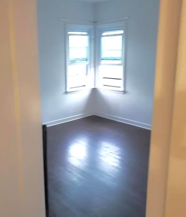 spare room with dark hardwood / wood-style flooring