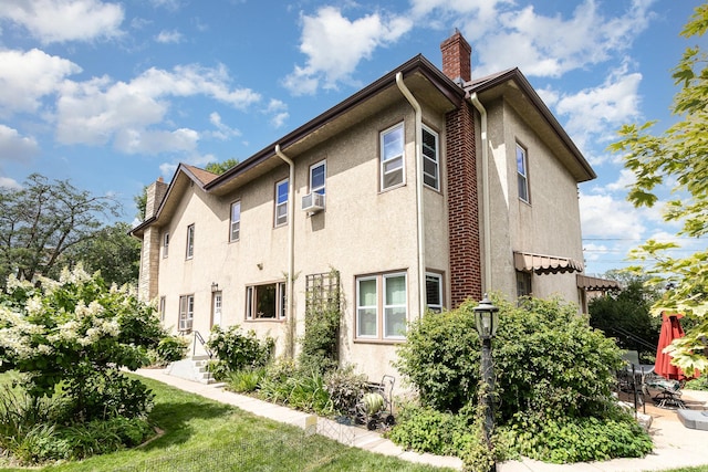 view of property exterior featuring a wall mounted air conditioner