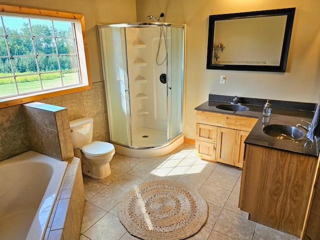 full bathroom featuring toilet, tile patterned flooring, tile walls, shower with separate bathtub, and vanity