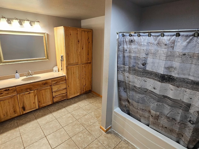 bathroom with tile patterned flooring, shower / bathtub combination with curtain, and vanity