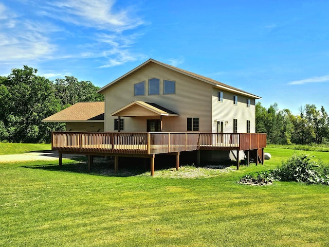 rear view of property featuring a wooden deck and a yard