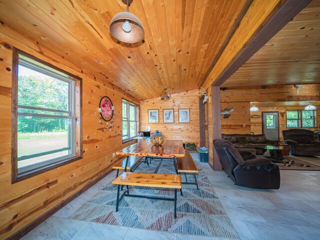 tiled dining space featuring lofted ceiling, wood walls, and wooden ceiling