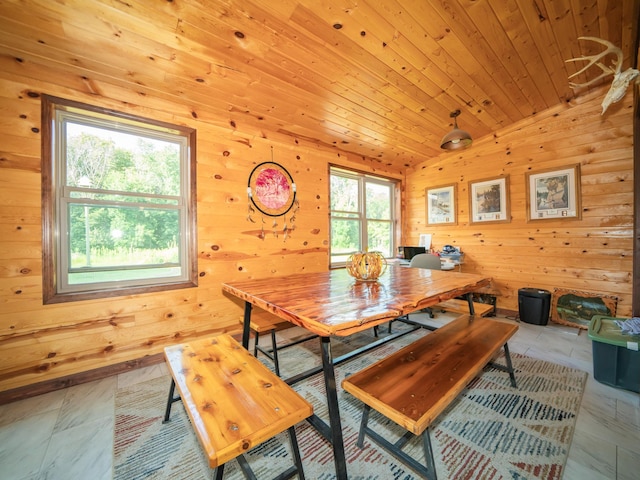 tiled dining space featuring wood walls, wooden ceiling, and lofted ceiling