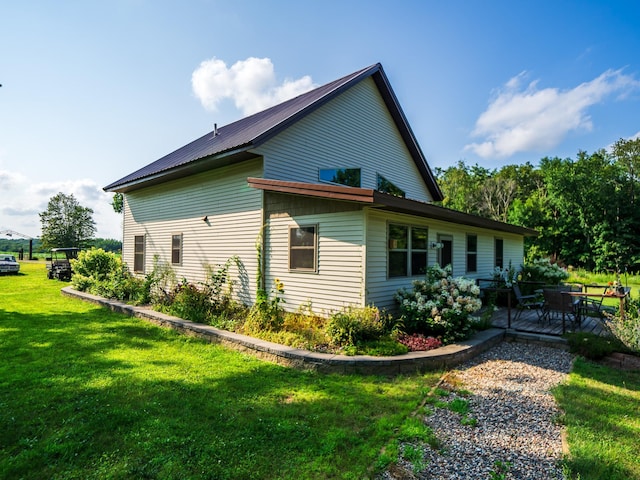 view of home's exterior with a lawn