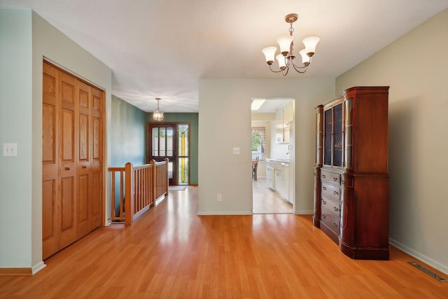 interior space with a chandelier and light hardwood / wood-style flooring