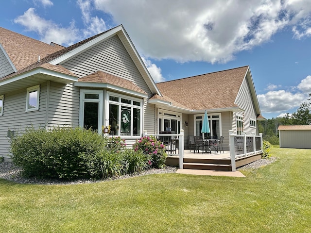 back of house with a lawn and a wooden deck