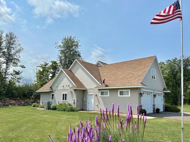 1225 Dorothy St, Isle, MN 56342 - view of front of house with a front yard, cooling unit, roof with shingles, and asphalt driveway