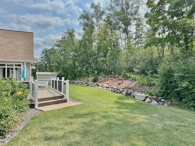 1225 Dorothy St, Isle, MN 56342 - view of green lawn featuring a deck and an outbuilding
