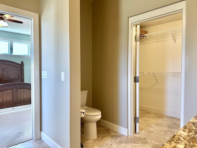 1225 Dorothy St, Isle, MN 56342 - bathroom with toilet, baseboards, a spacious closet, and ceiling fan