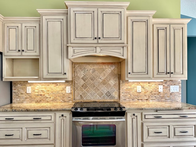 1225 Dorothy St, Isle, MN 56342 - kitchen featuring stainless steel electric stove, cream cabinets, and backsplash