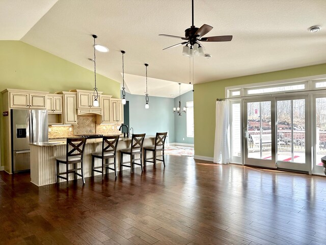 1225 Dorothy St, Isle, MN 56342 - kitchen featuring cream cabinetry, stainless steel refrigerator with ice dispenser, lofted ceiling, a ceiling fan, and a breakfast bar