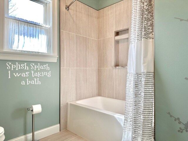1225 Dorothy St, Isle, MN 56342 - bathroom featuring shower / tub combo, toilet, and baseboards