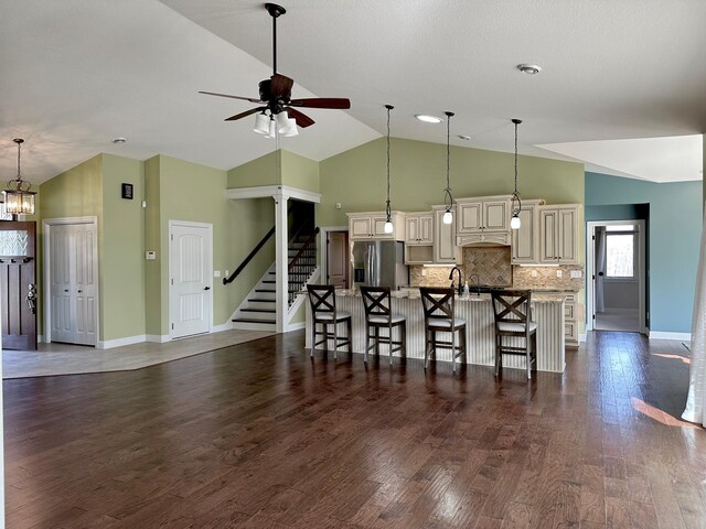 1225 Dorothy St, Isle, MN 56342 - kitchen featuring stainless steel refrigerator with ice dispenser, cream cabinets, a kitchen bar, ceiling fan, and a large island