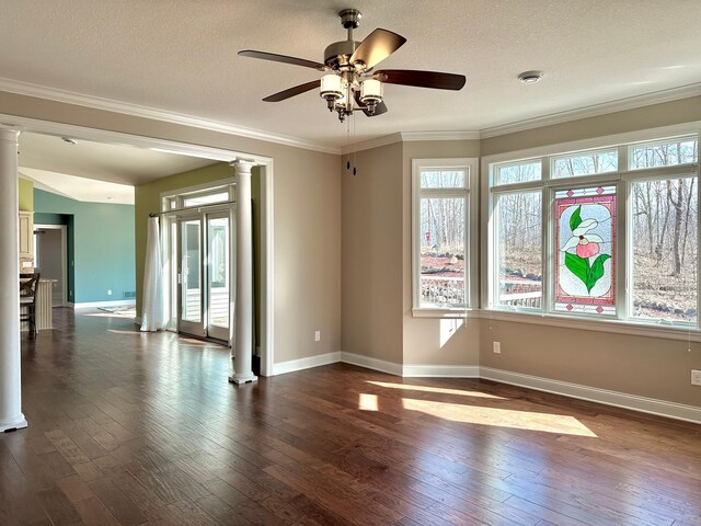 1225 Dorothy St, Isle, MN 56342 - empty room featuring decorative columns, healthy amount of natural light, dark wood-type flooring, a ceiling fan, and a textured ceiling