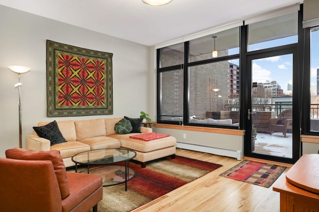 living room with baseboard heating, hardwood / wood-style flooring, and expansive windows