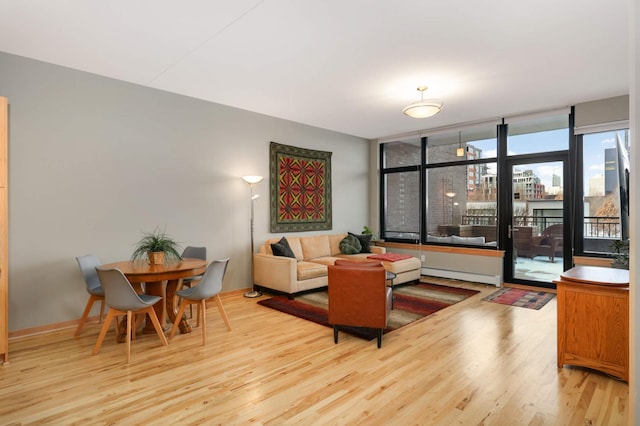 living room featuring light hardwood / wood-style floors and a baseboard radiator