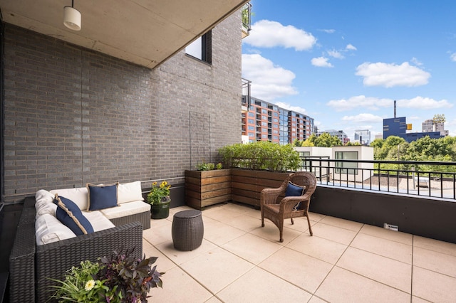 view of patio featuring a balcony and outdoor lounge area