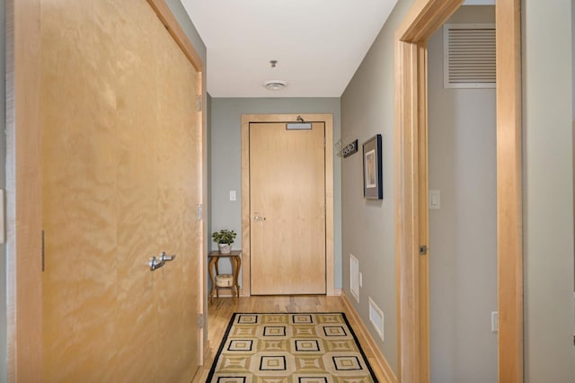 doorway to outside with wood-type flooring