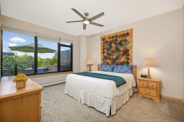 carpeted bedroom with ceiling fan and a baseboard radiator