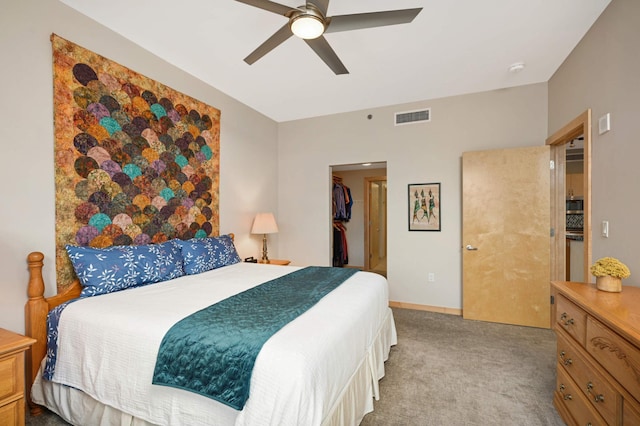 bedroom with ceiling fan, light colored carpet, and a closet