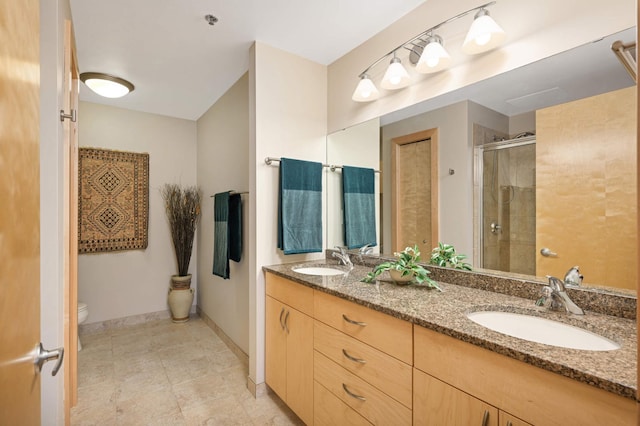 bathroom with toilet, vanity, and an enclosed shower