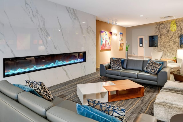 living room featuring dark hardwood / wood-style floors and a high end fireplace