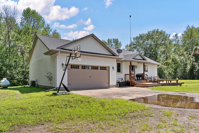 ranch-style house with an attached garage, roof with shingles, concrete driveway, and a front yard
