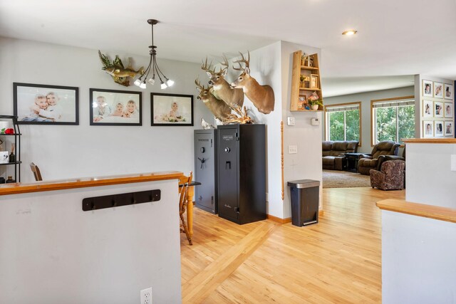 kitchen featuring light wood-type flooring and an inviting chandelier
