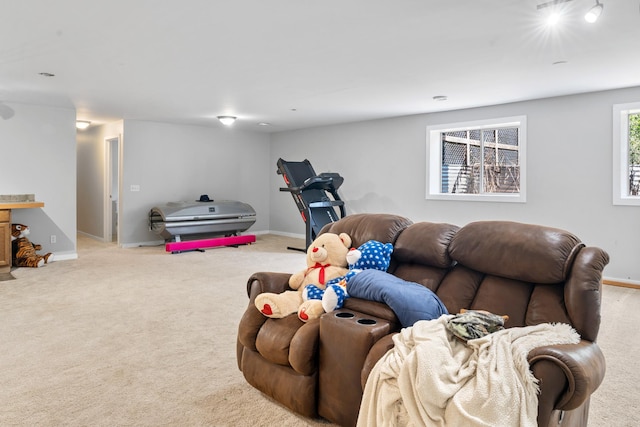carpeted living room with baseboards