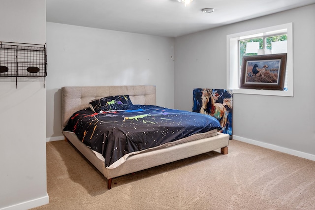 bedroom featuring baseboards and carpet