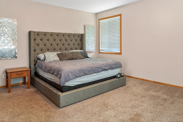 carpeted bedroom featuring baseboards