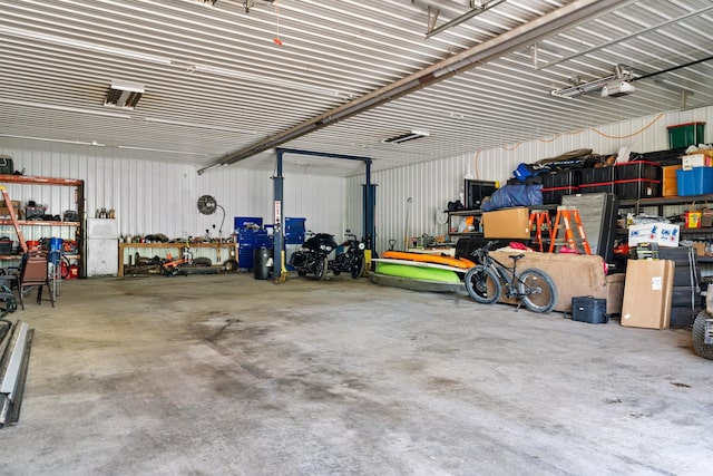 garage featuring metal wall and a workshop area