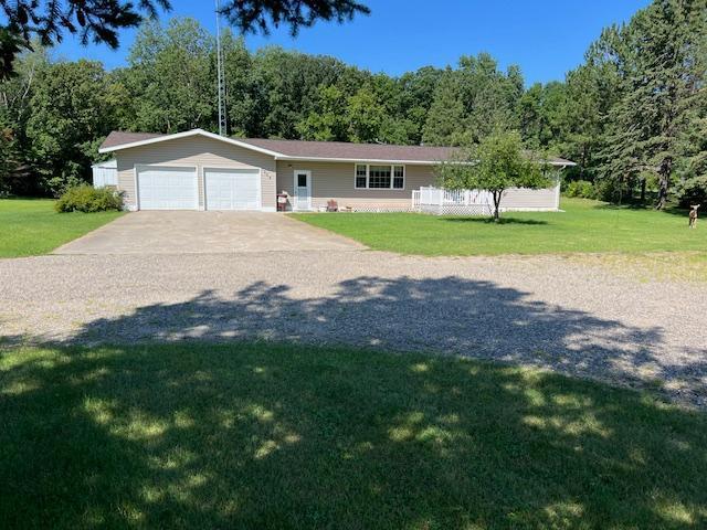 single story home featuring a garage and a front lawn