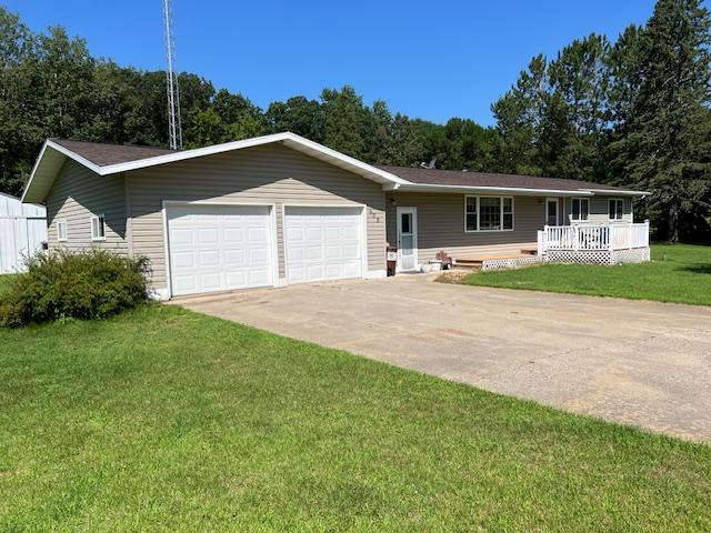 ranch-style home featuring a garage and a front yard