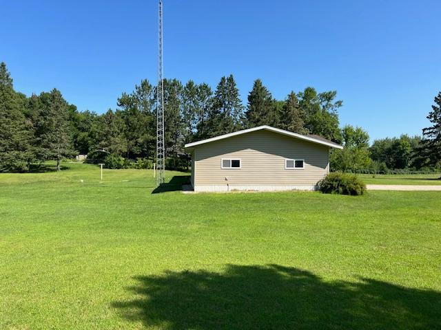 view of side of home featuring a lawn