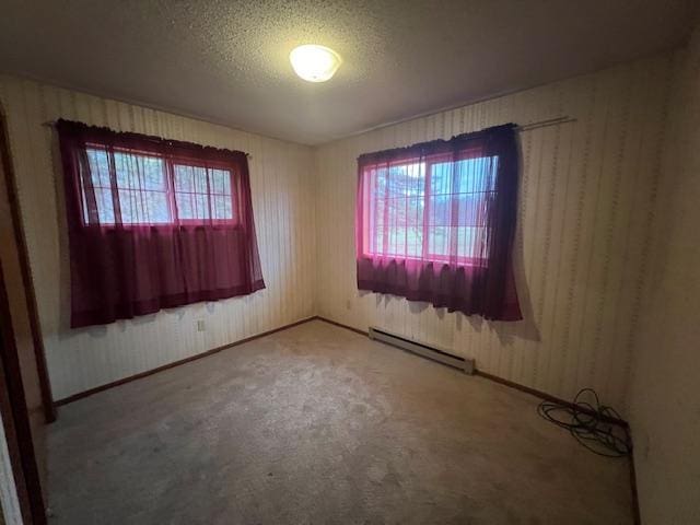 spare room with a baseboard radiator and a textured ceiling