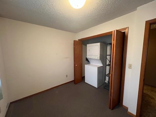 washroom with stacked washing maching and dryer, carpet flooring, and a textured ceiling