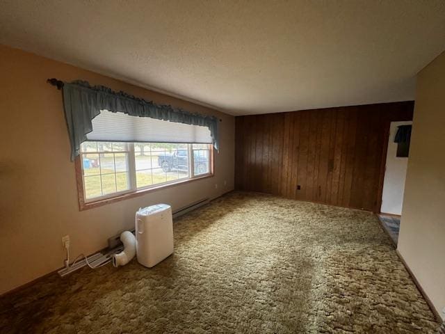 unfurnished room featuring wooden walls and carpet flooring